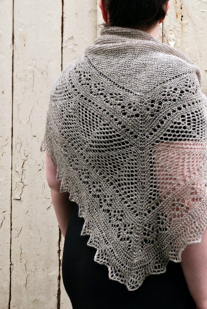 Woman wears a grey lace shawl with plain centre