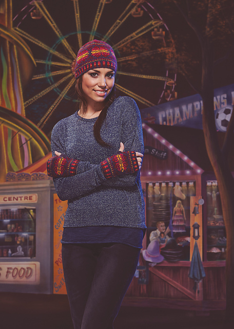 Woman wears blue jumper and purple + orange hat and mitts
